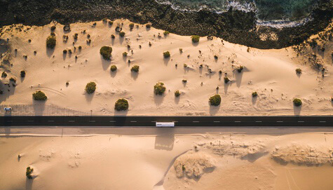 Bus traveling along winding road symbolizing journey versus true story conflict
