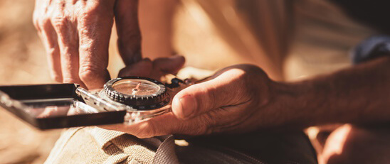 Man holding compass symbolizing guidance and decision in life transformation